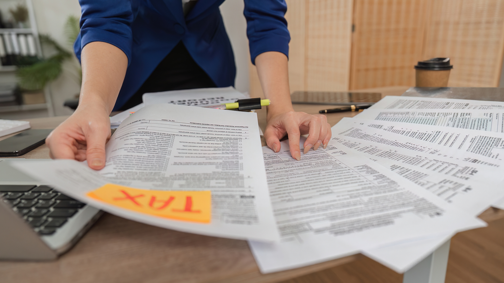 Tax paperwork and office supplies on desk