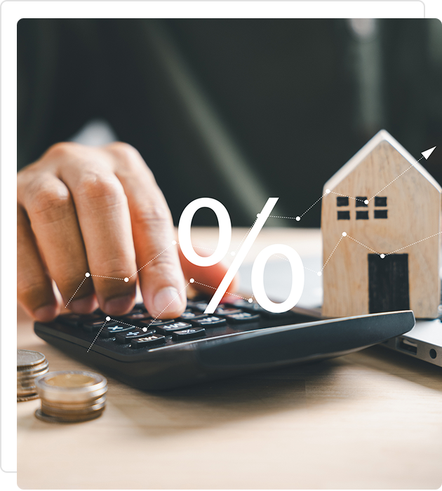 Person calculating home loan interest with a calculator and house model.